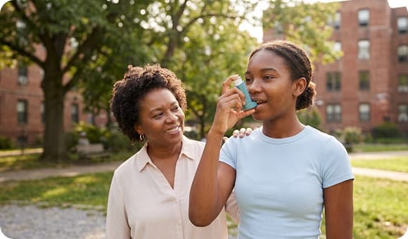 Founder assisting a young patient with an inhaler outdoors